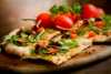 Pizza with ruccola and red tomatoes