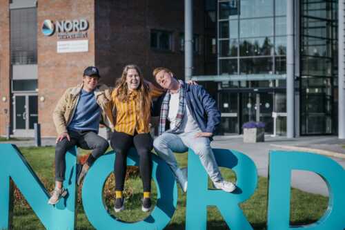 Three happy students outside Nord University